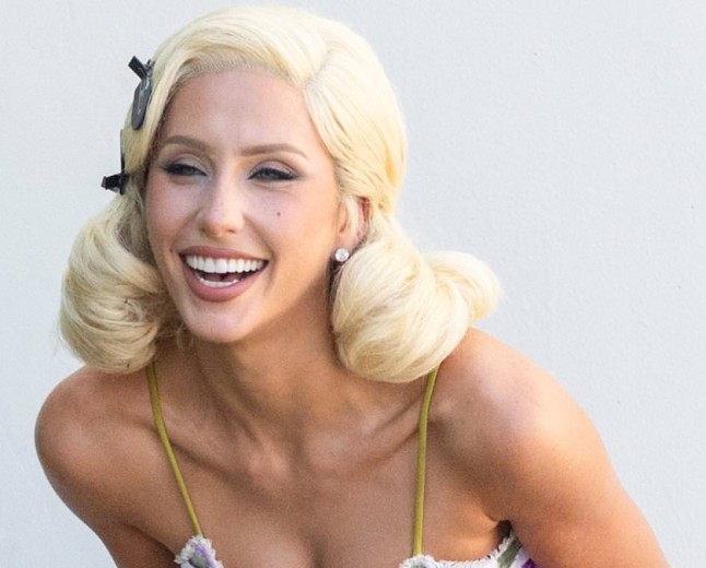 Alix Earle puffs on a cigarette in platinum blonde wig and tiny mini dress during pinup photo shoot