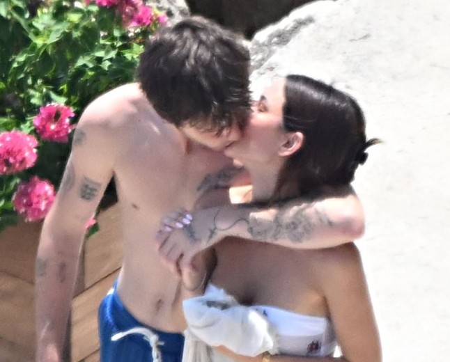 Cruz Beckham, 21, plants a passionate kiss on his bikini-clad girlfriend Jackie Apostel, 30, as they soak up the sun during family trip to the Amalfi Coast