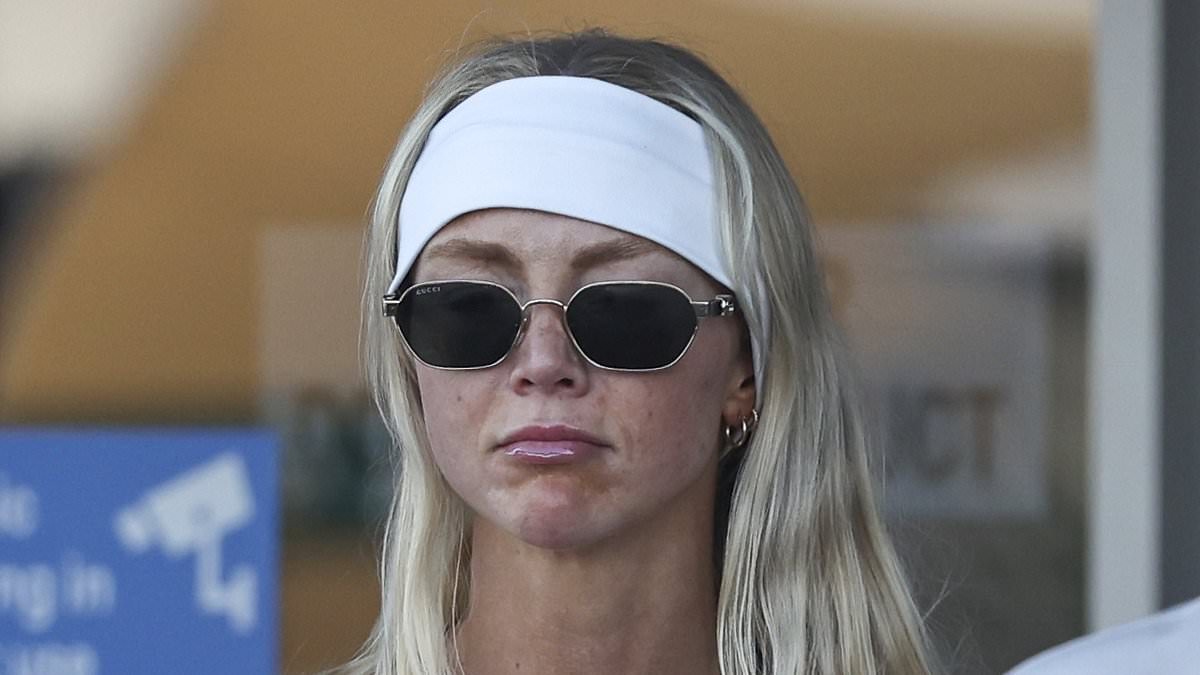 Annie Knight goes makeup free as she arrives on the Gold Coast with her fiancé Henry Brayshaw carrying her wedding dress ahead of their impending nuptials