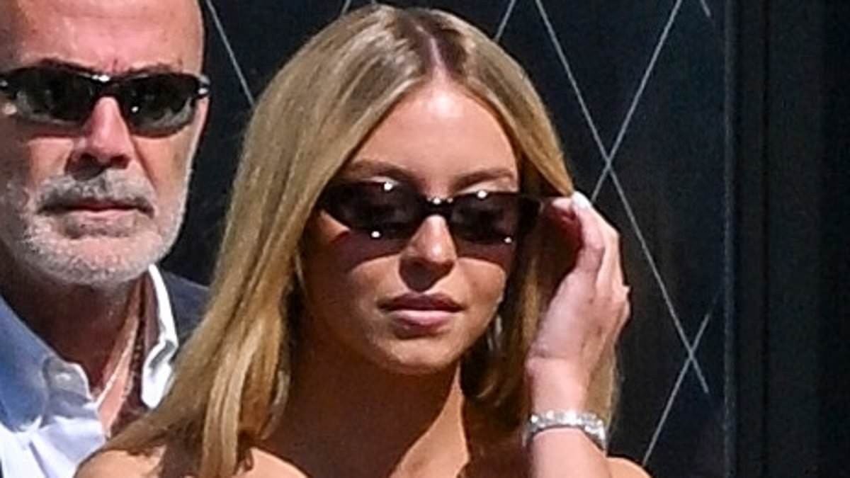 Sydney Sweeney slips into a white mini dress as she ropes her friend into being her social media manager during water taxi ride in Venice