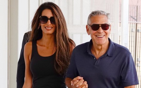 Amal Clooney wows in £1,695 snake print Elie Saab skirt as she links arms with husband George Clooney as they leave the 83rd Venice Film Festival