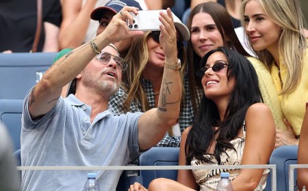 Brad Pitt, 62, snaps selfies with adoring fans and cuddles up to girlfriend Ines de Ramon, 33, during carefree day at US Open as ex Angelina Jolie speaks out on raising his estranged kids
