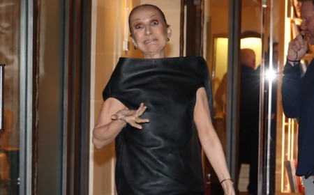Celine Dion looks giddy as she returns to her hotel ahead of her Paris residency after dancing in the street
