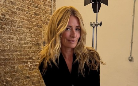 Cat Deeley poses cross-legged in a blazer minidress and jokes 'all you need is a bar stool and a leaf blower'