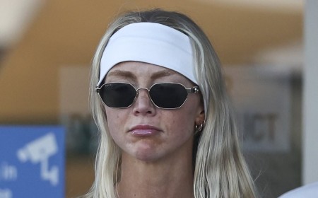 Annie Knight goes makeup free as she arrives on the Gold Coast with her fiancé Henry Brayshaw carrying her wedding dress ahead of their impending nuptials