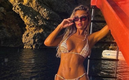 Christine McGuinness poses in her bikini on a pedalo boat on holiday as she escapes the London rain