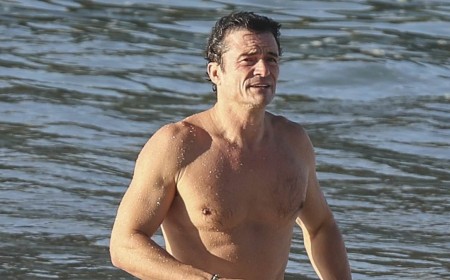 Orlando Bloom, 49, shows off his ripped physique as he emerges from the sea after a swim in Spain