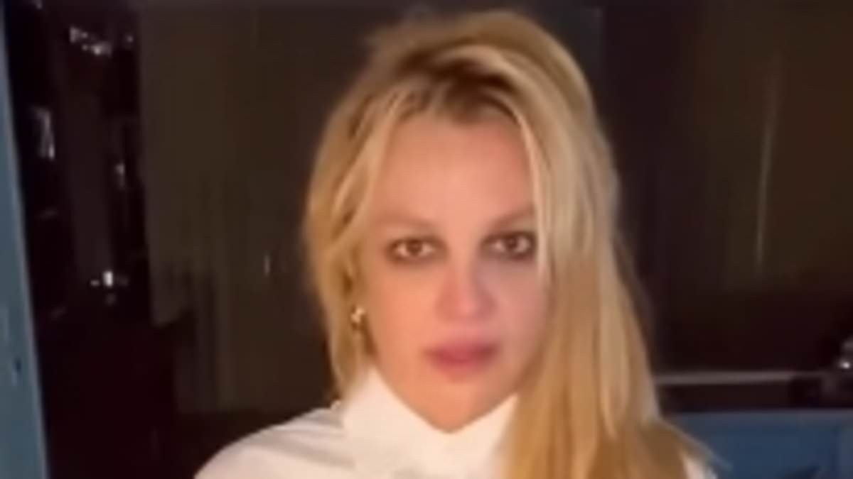 Britney Spears says the world has been 'hateful' to her as she flashes midriff in miniskirt and cropped blouse