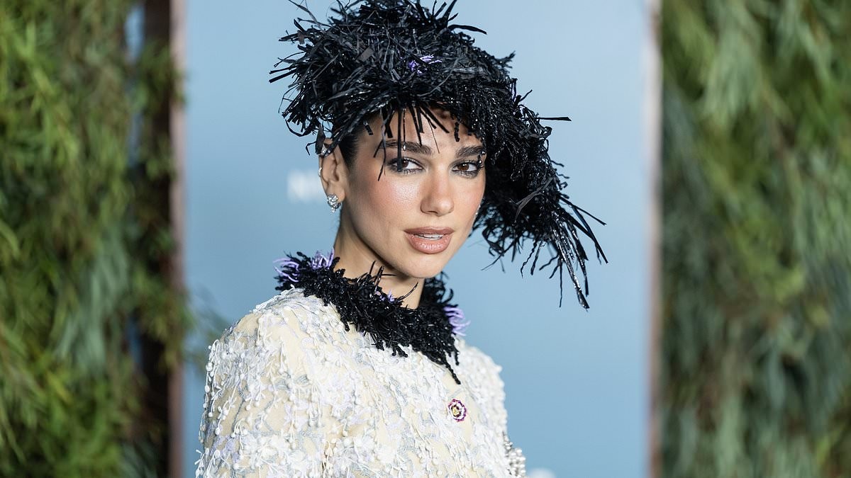 Dua Lipa teams her Chanel suit with a  kooky hat as she joins Cara Delevingne to honour her wedding dress designer Matthieu Blazy at WSJ. Magazine Innovator Awards
