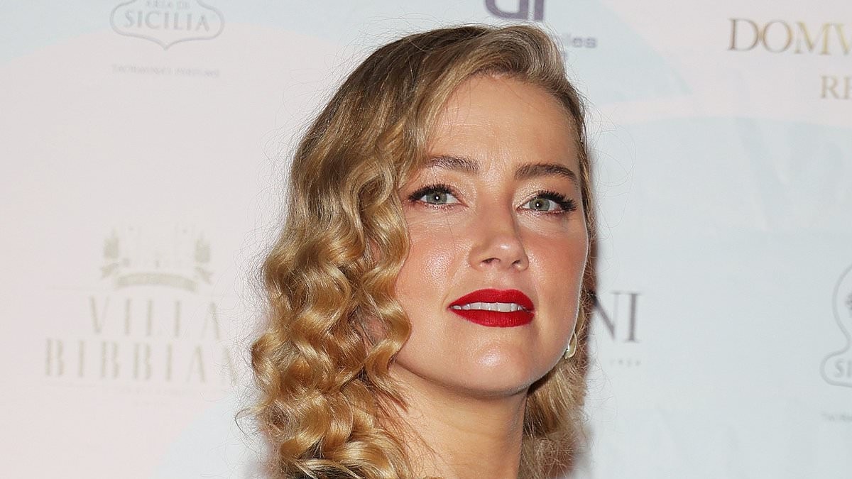 Carefree Amber Heard flips her hair and smiles in selfie snapped by daughter Oonagh, five, as her ex Johnny Depp sets major Hollywood comeback