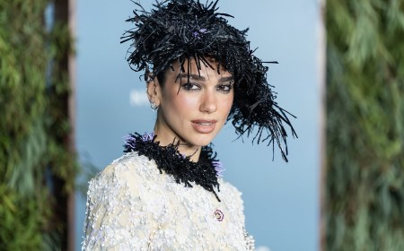 Dua Lipa teams her Chanel suit with a  kooky hat as she joins Cara Delevingne to honour her wedding dress designer Matthieu Blazy at WSJ. Magazine Innovator Awards
