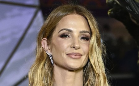 Millie Mackintosh masters 'revenge dressing' in a deeply plunging gown at Hunger Games premiere as she takes aim at Hugo Taylor once again with pointed 'kisses to my exes' post