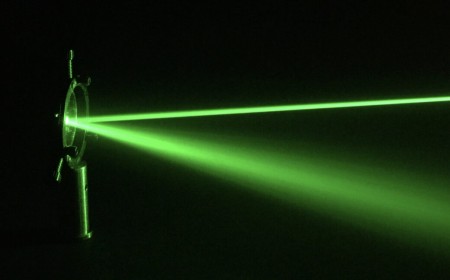An experimental tour-de-force: Entanglement between glass bead and light