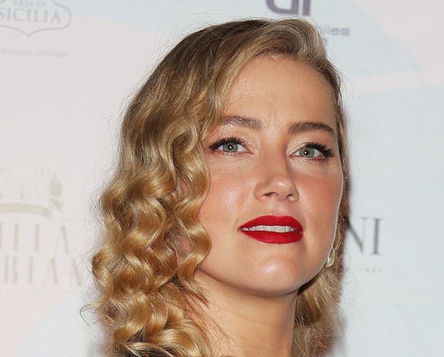 Carefree Amber Heard flips her hair and smiles in selfie snapped by daughter Oonagh, five, as her ex Johnny Depp sets major Hollywood comeback