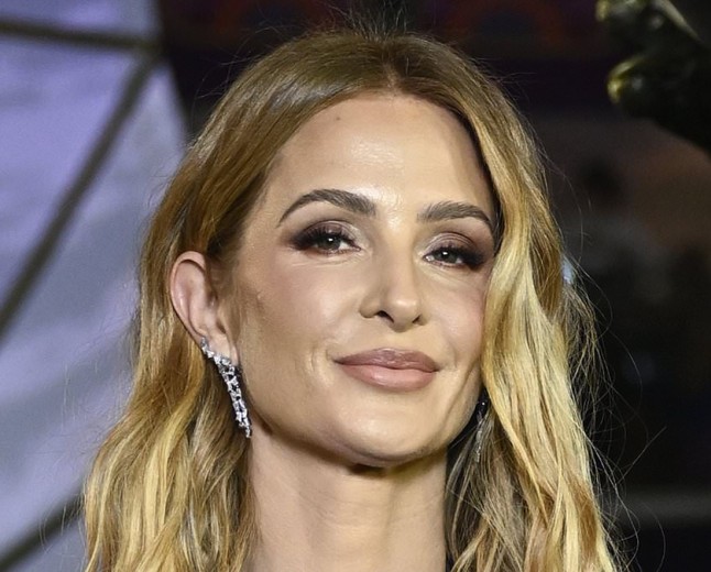 Millie Mackintosh masters 'revenge dressing' in a deeply plunging gown at Hunger Games premiere as she takes aim at Hugo Taylor once again with pointed 'kisses to my exes' post